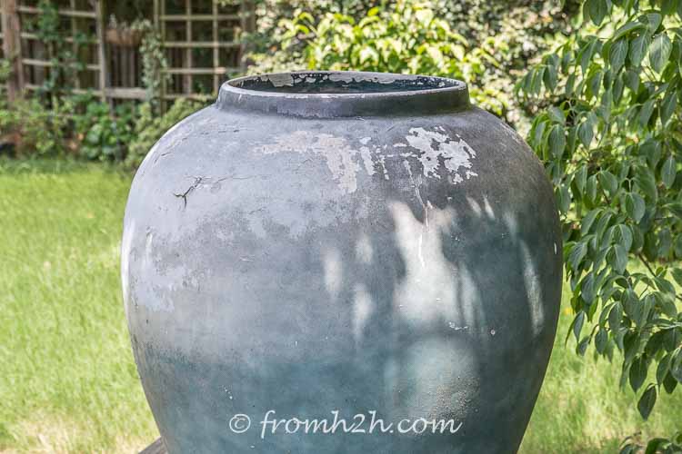 Large outdoor urn with the paint peeling off