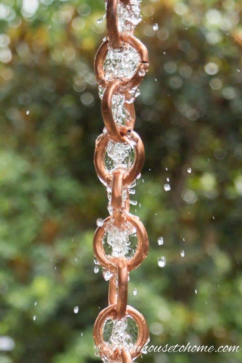 Rain chain links with water flowing down them