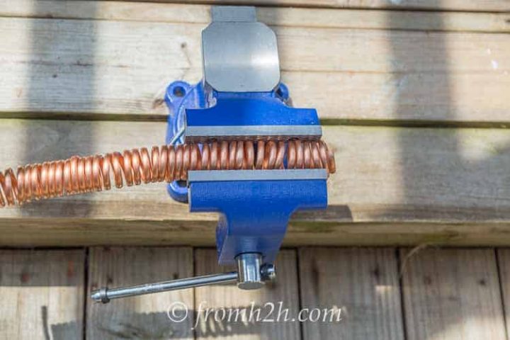 Use a bench vise to hold the links still