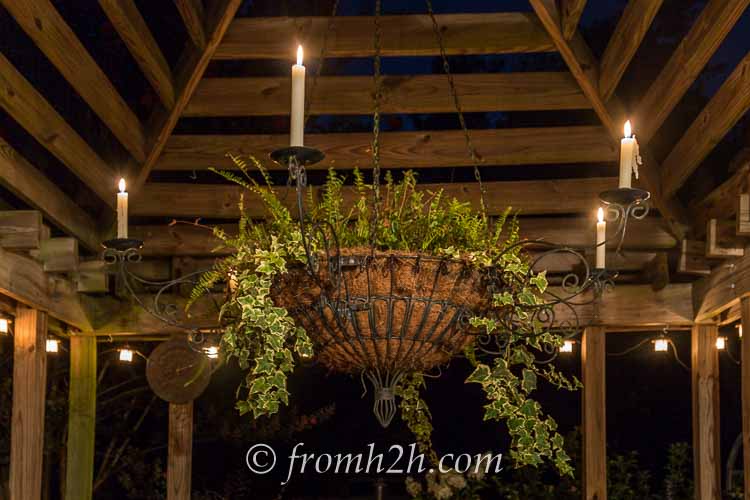 An outdoor candle chandelier adds ambiance | 10 Beautiful Ways To Light Your Garden