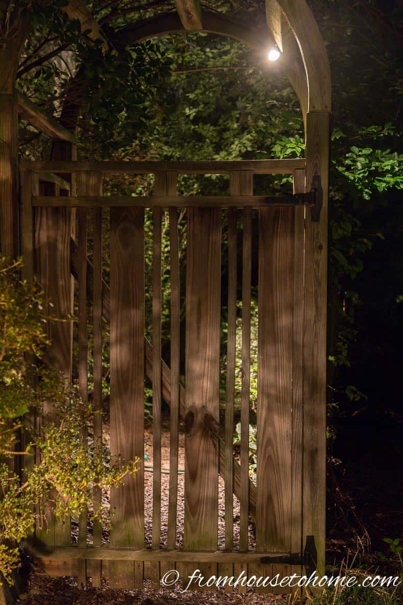 Downlighting an arbor is an easy way to light the sidewalk | How To Design And Install Landscape Lighting