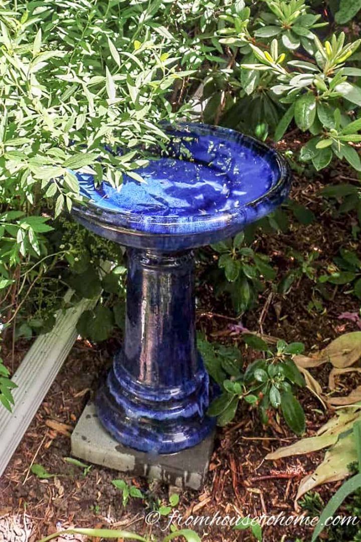Blue ceramic bird bath in the garden