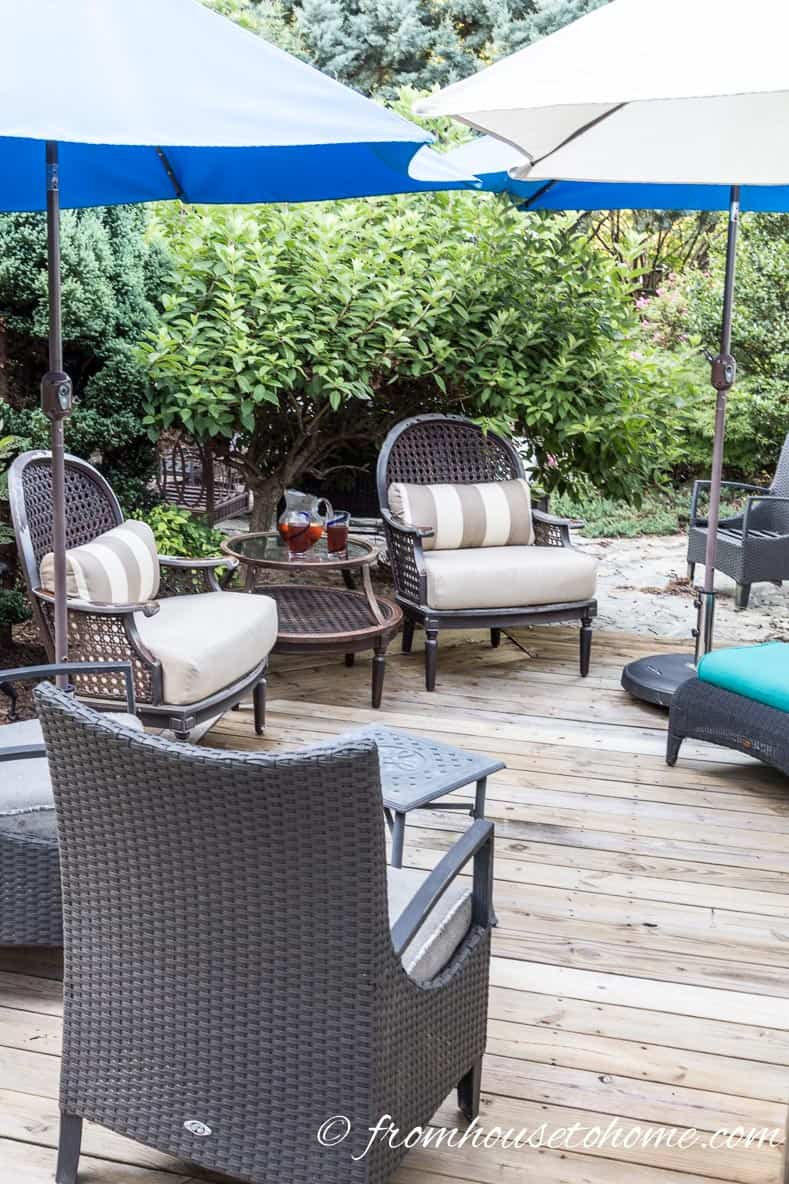 Blue and white patio umbrellas over outdoor furniture on a deck