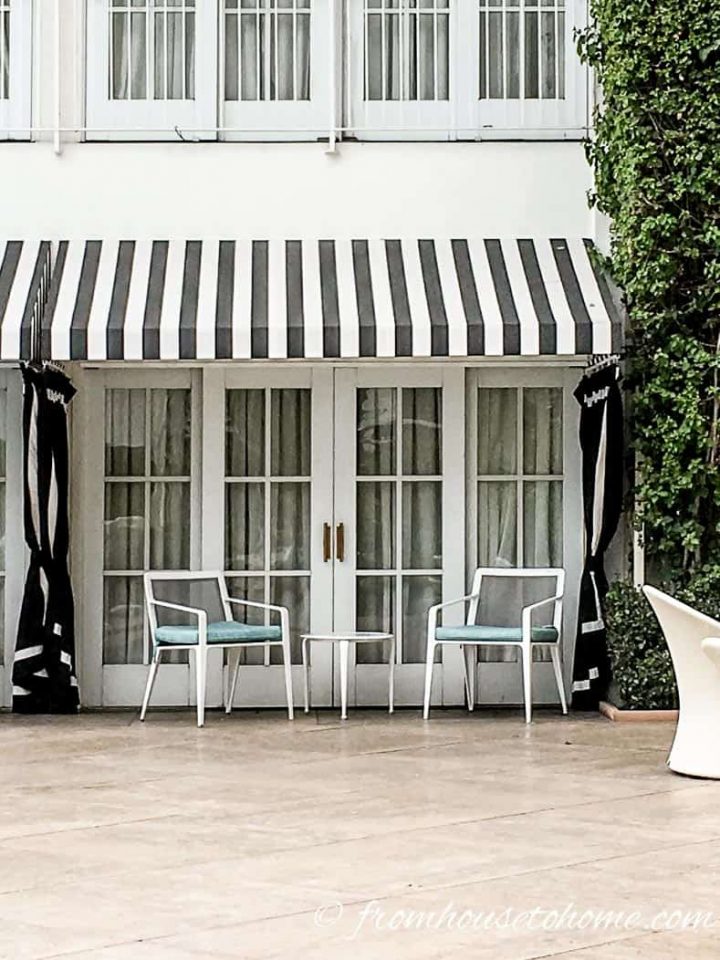 Beverly Hilton poolside room with black and white awning