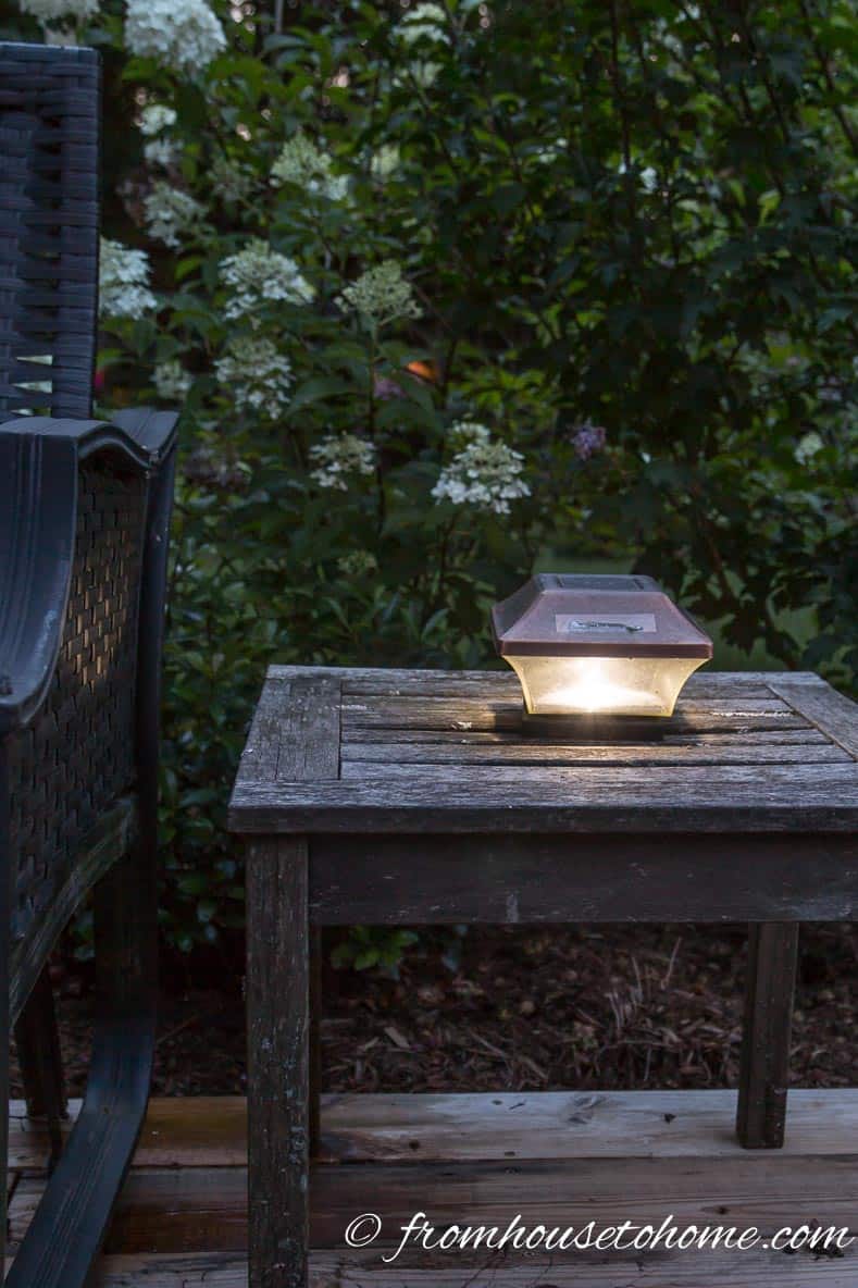 Post light used as a table lamp | 8 Landscape Lighting Effects And How To Use Them | Whether you're looking for DIY landscape lighting ideas for your front yard, backyard or walkway, this list will help! It shows you lots of ways to use both low voltage and solar lights in your garden or patio.