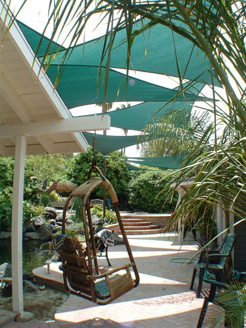 Shade sails provide backyard shade for this patio by shadesails.com