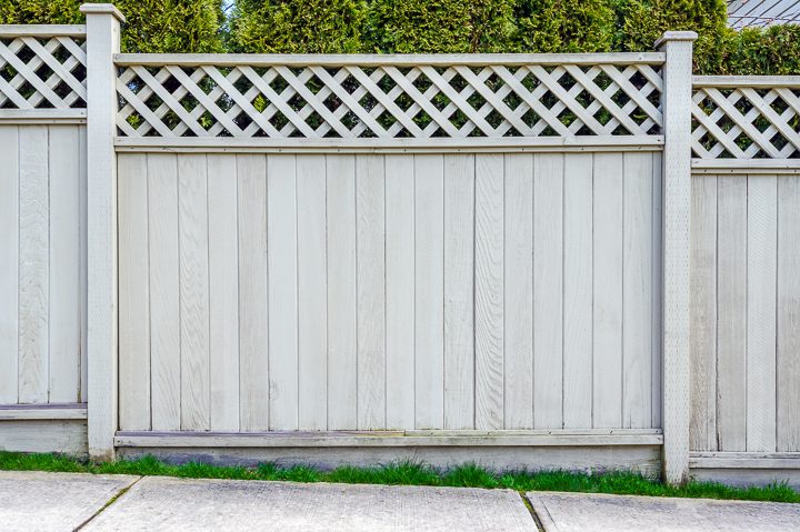 Grey wood privacy fence with lattice top