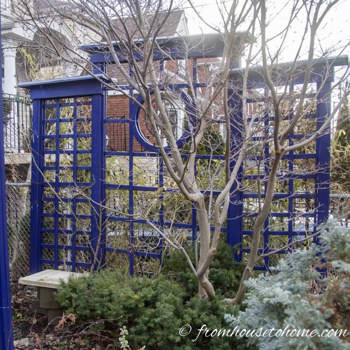 Blue trellis privacy fence with circle cutout