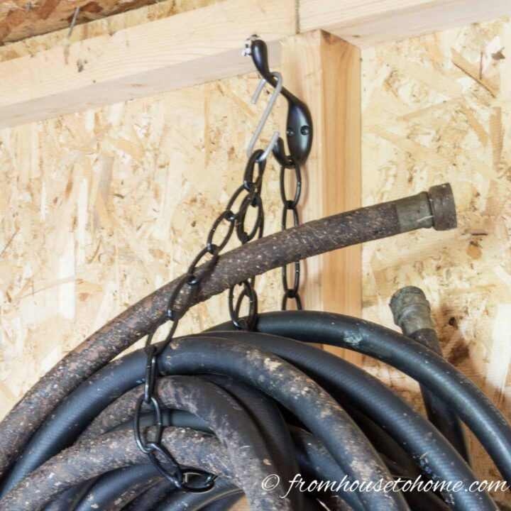 Hooks and chains hang up hoses in the shed