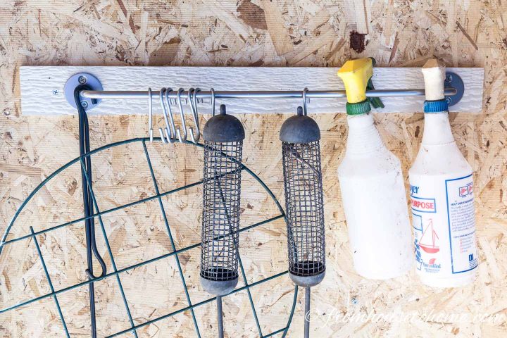 Use a kitchen rod to hang spray bottles and other garden tools