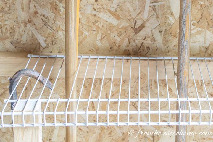 Cut the wires on wire shelves to make holes for storing garden tools like rakes