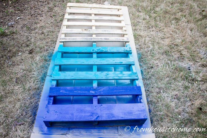 Bottom slats of a pallet painted in two colors of blue