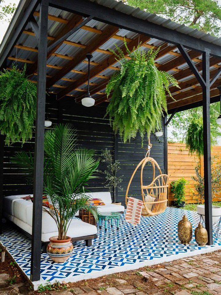 Pergola with a tin roof covering a blue and white patio