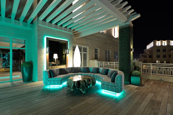 Pergola with modern LED rope lights under sofa