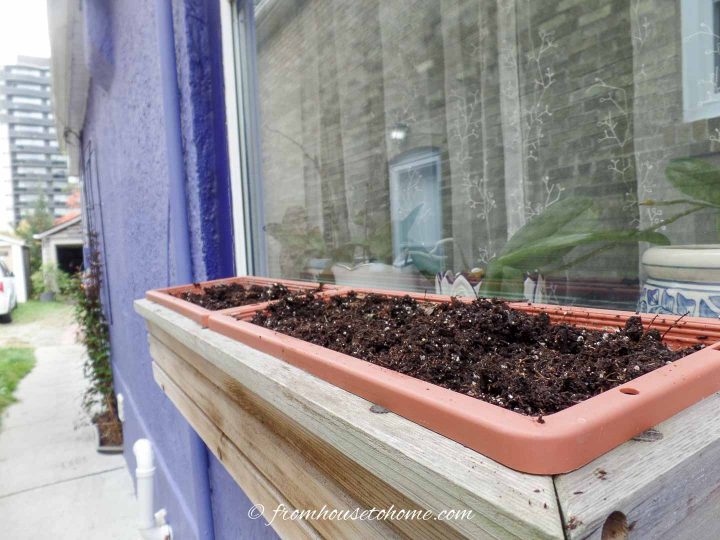 A window box filled with dirt