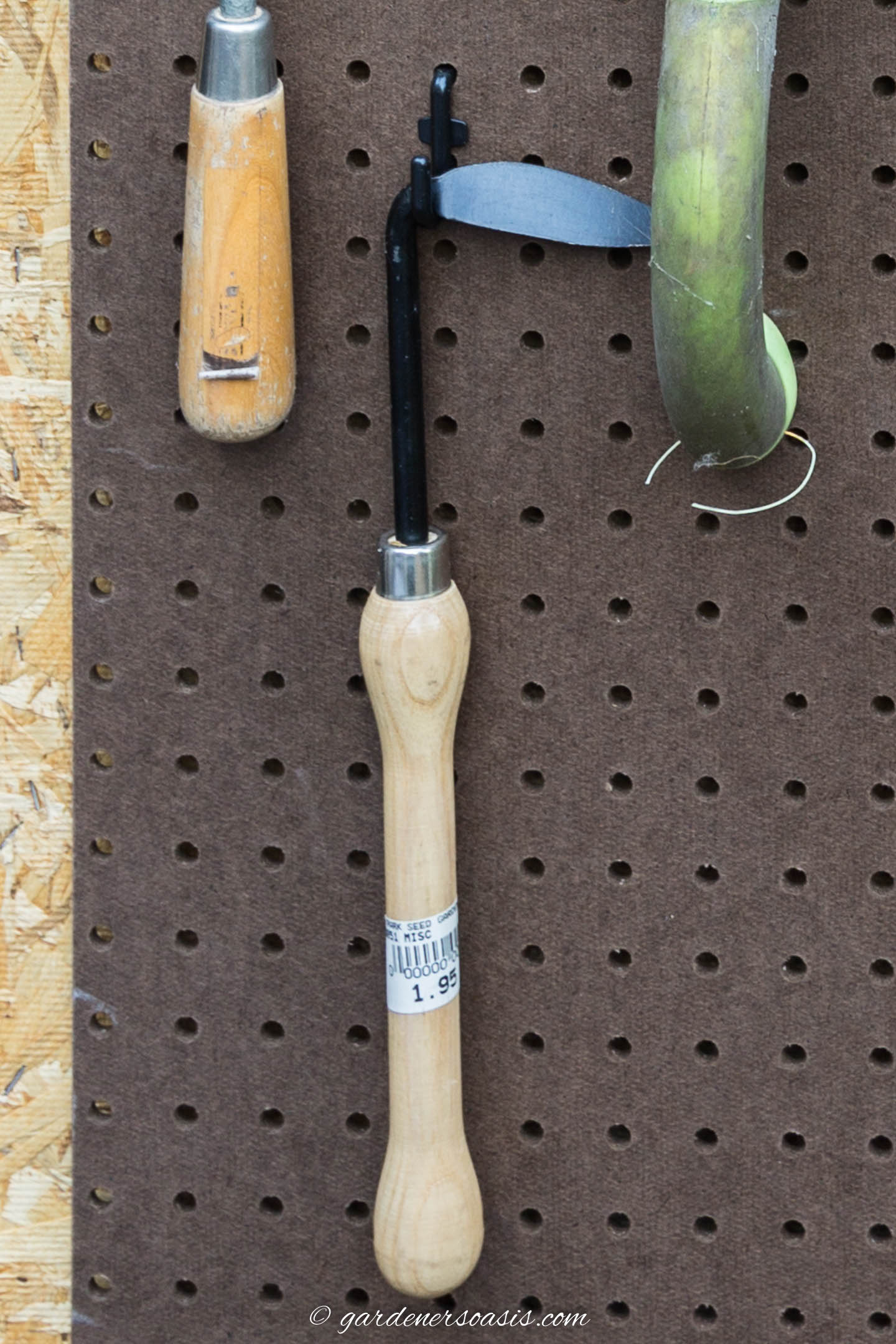 Crevice weeder hung on pegboard with a J hook