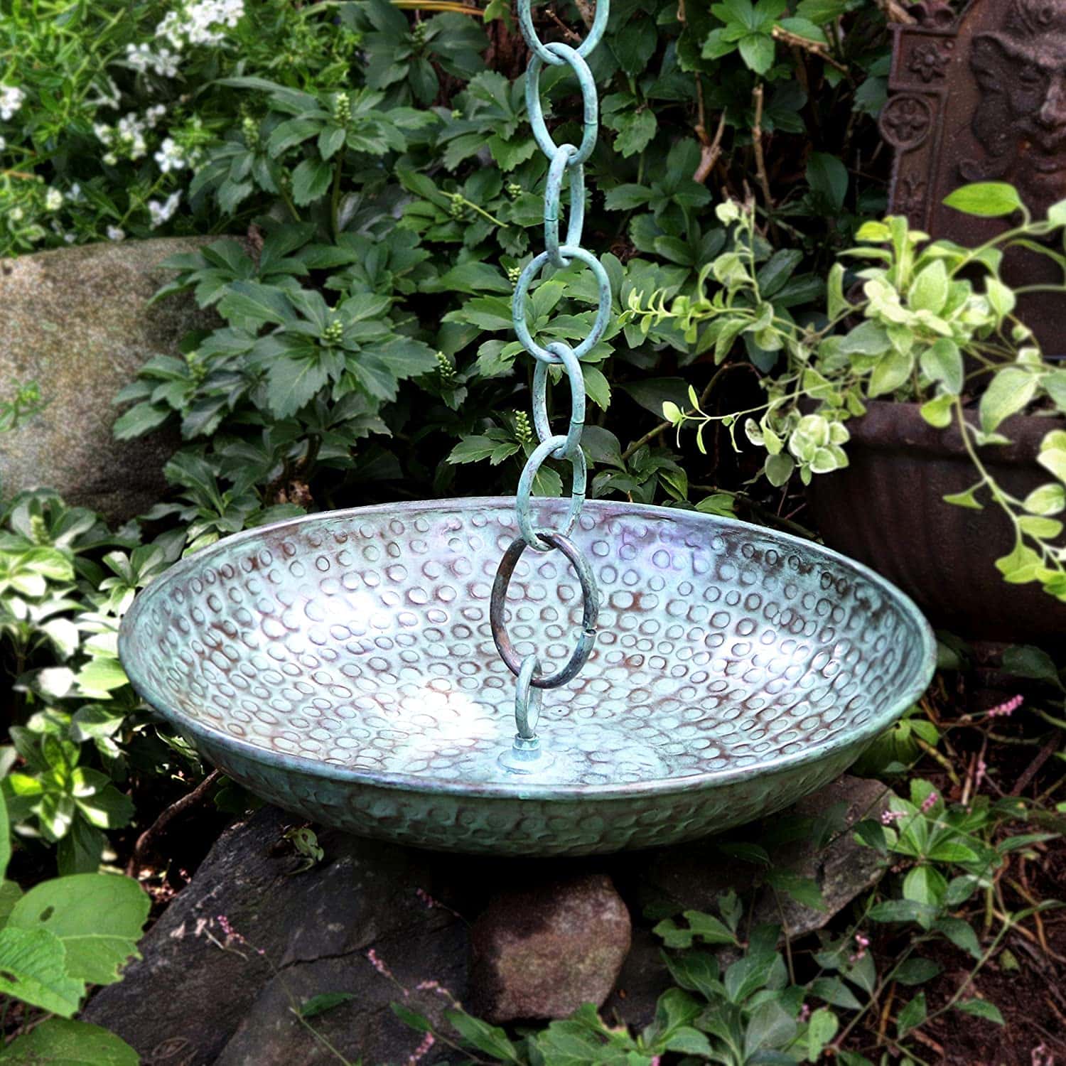 blue rain chain basin surrounded by plants