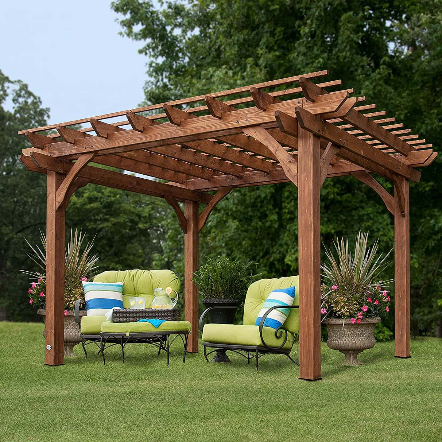 Large cedar pergola over two outdoor armchairs in the middle of a yard