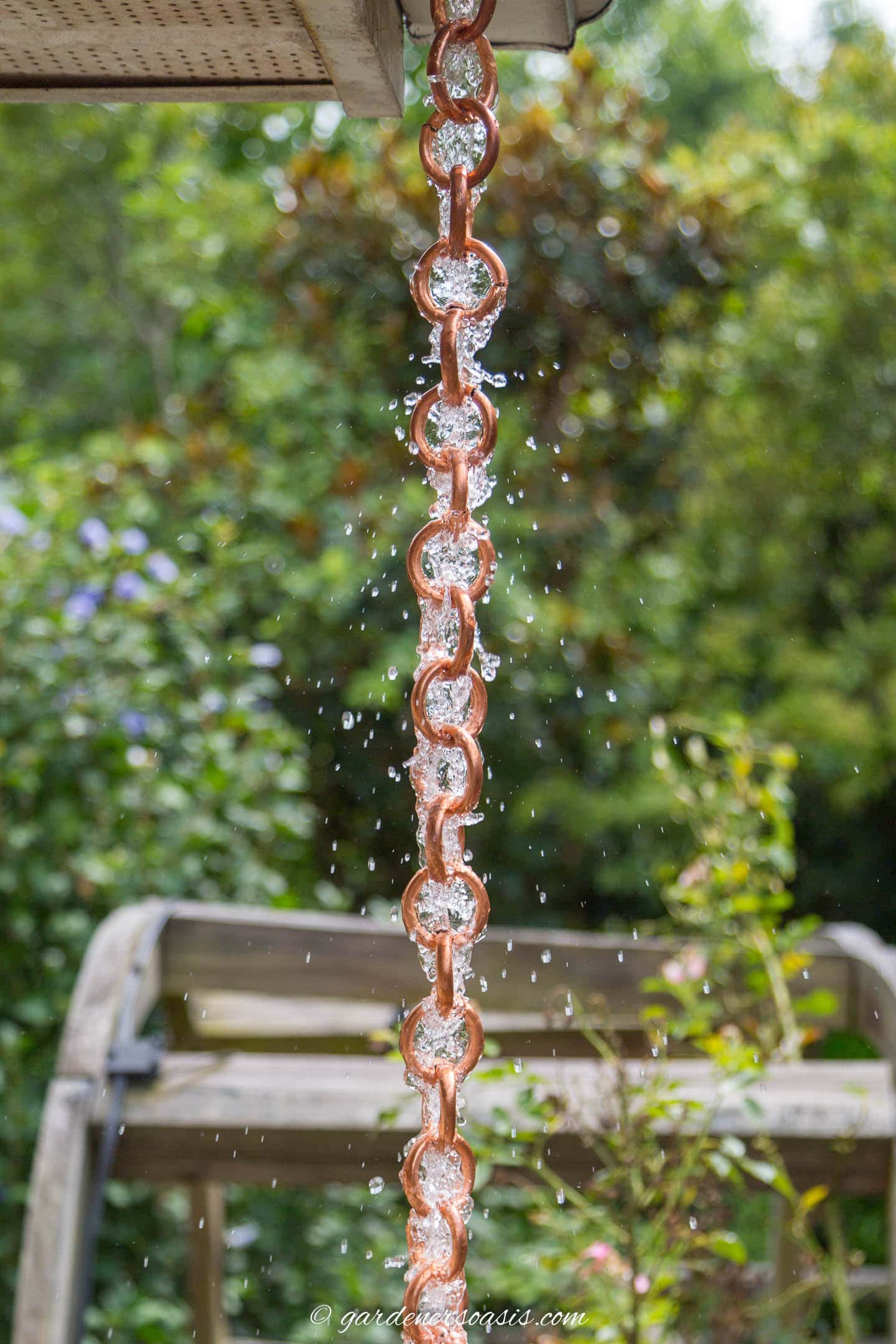 DIY copper link rain chain with water running down it
