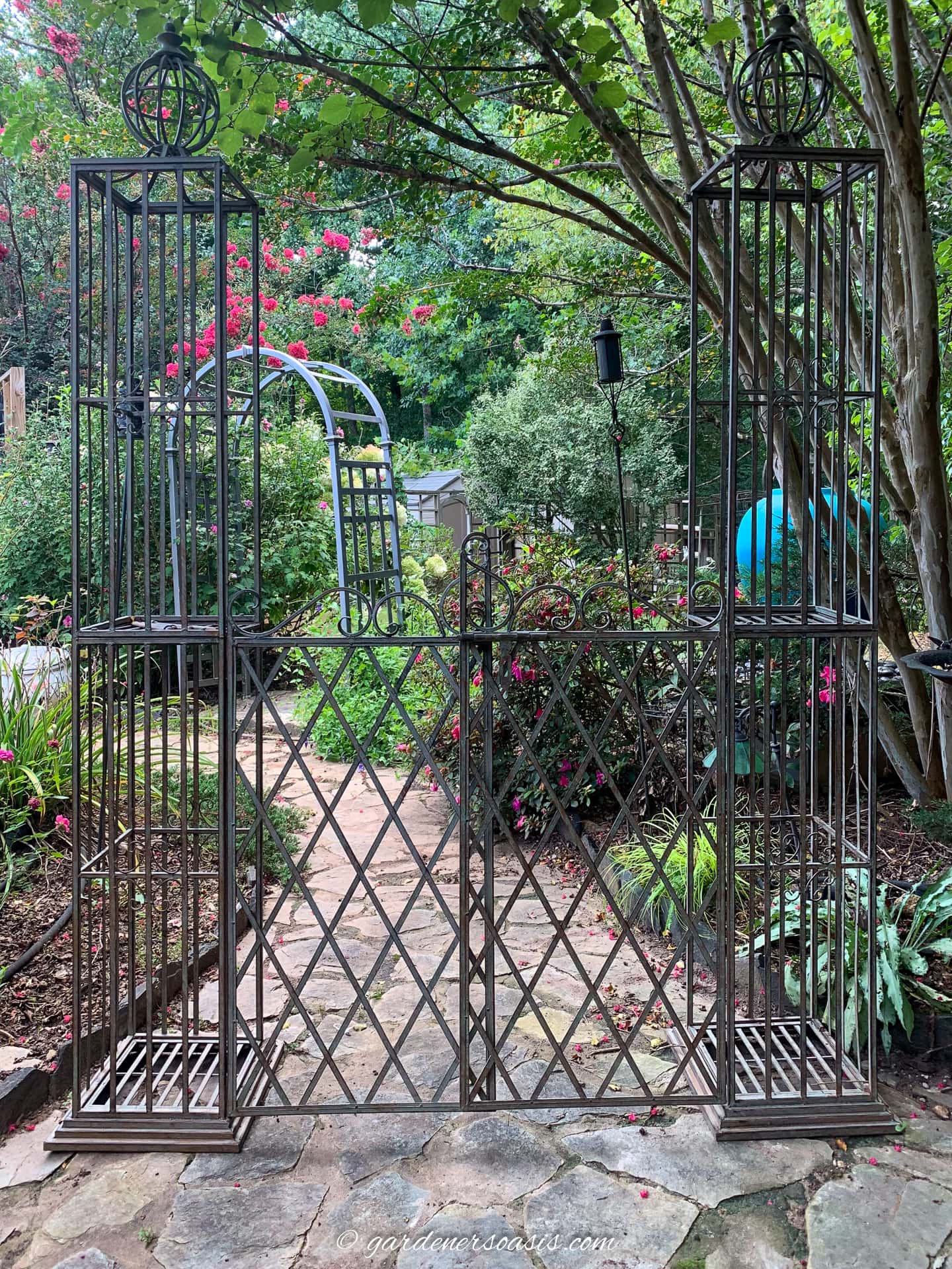 A metal gate in a garden.