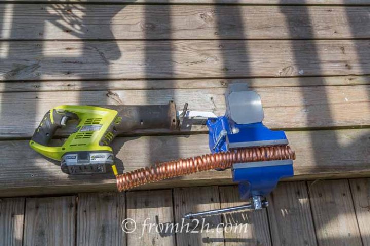 A bench vise and reciprocating saw make quick work of cutting the links
