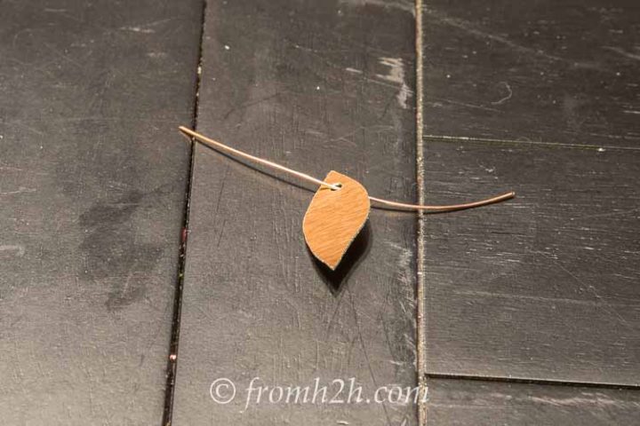Slip a piece of copper wire through the hole