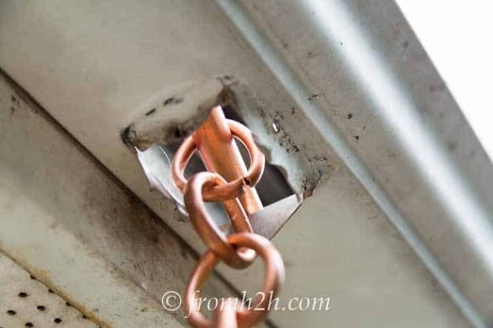 Using a straight pipe to hold the chain up doesn't funnel the water properly down the chain