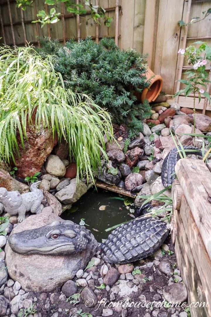 The water runs from the clay pot at the back through the rocks into the little pond