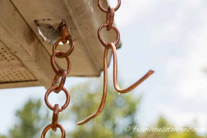 Pull the chain through the hole in the gutter and attach the holder