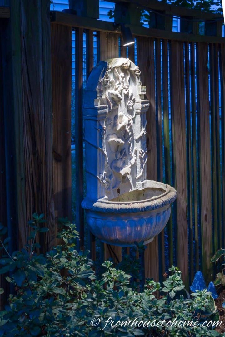 Use downlighting to highlight garden art or fountains on the fence